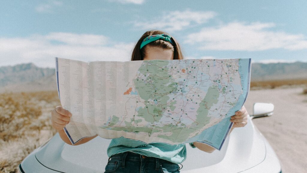 young woman planning a trip while maintaining her sobriety