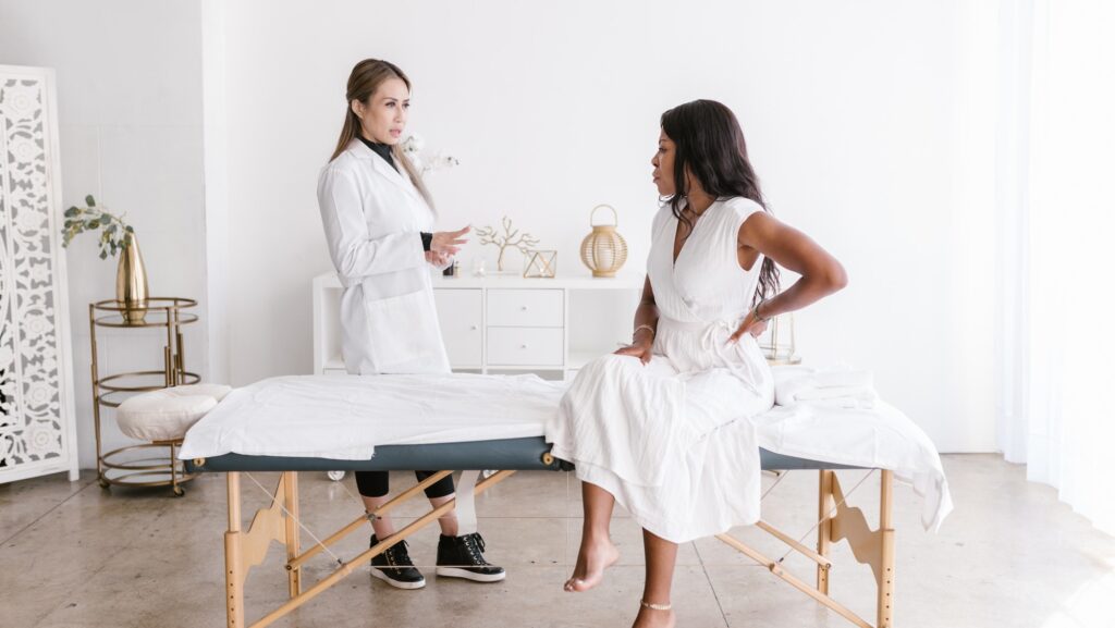girl receiving gentle chiropractic assistance from a therapist during care
