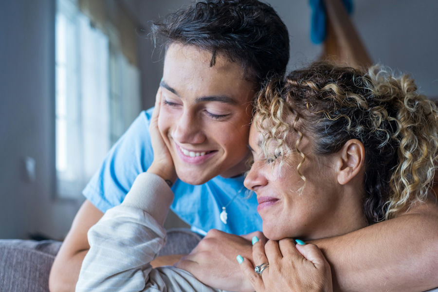 mom hugging her son, healing through family therapy