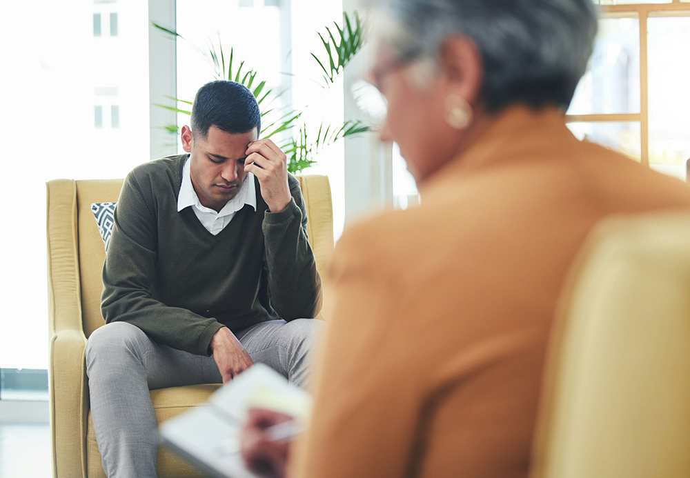man experiencing anxiety discussing it with his counselor