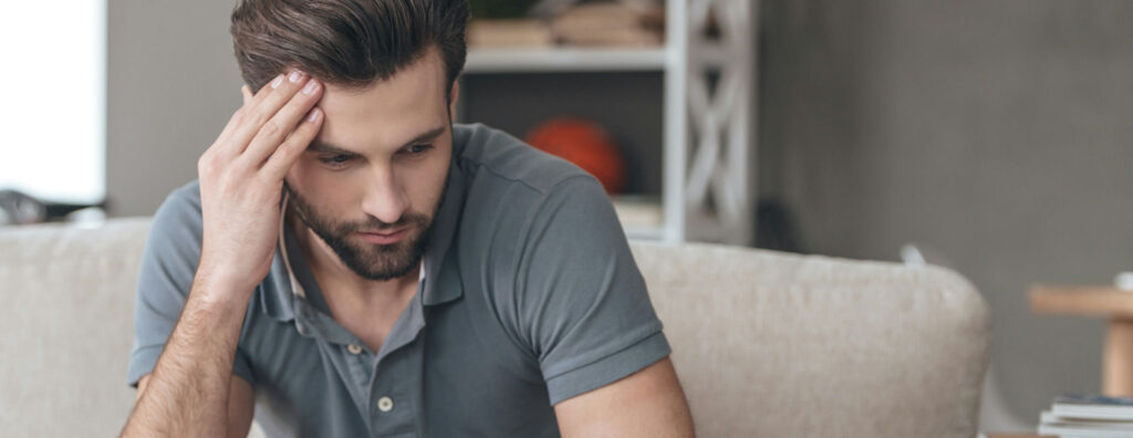 man with anxiety sitting in a counselor's