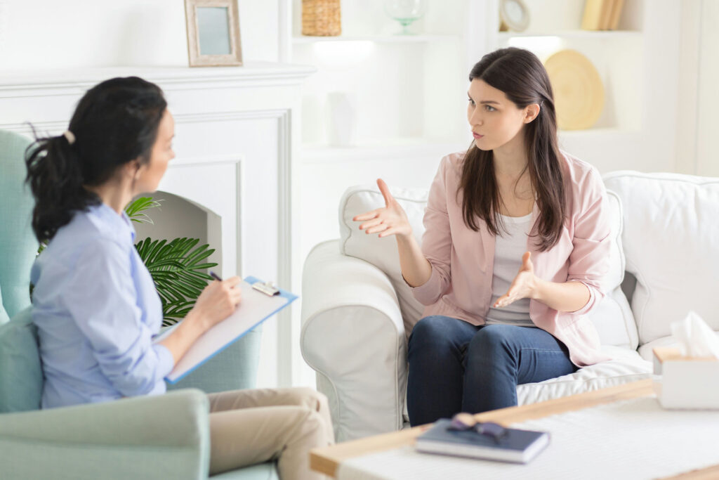 Therapist talking with a client during a supportive session for schizoaffective disorder treatment.
