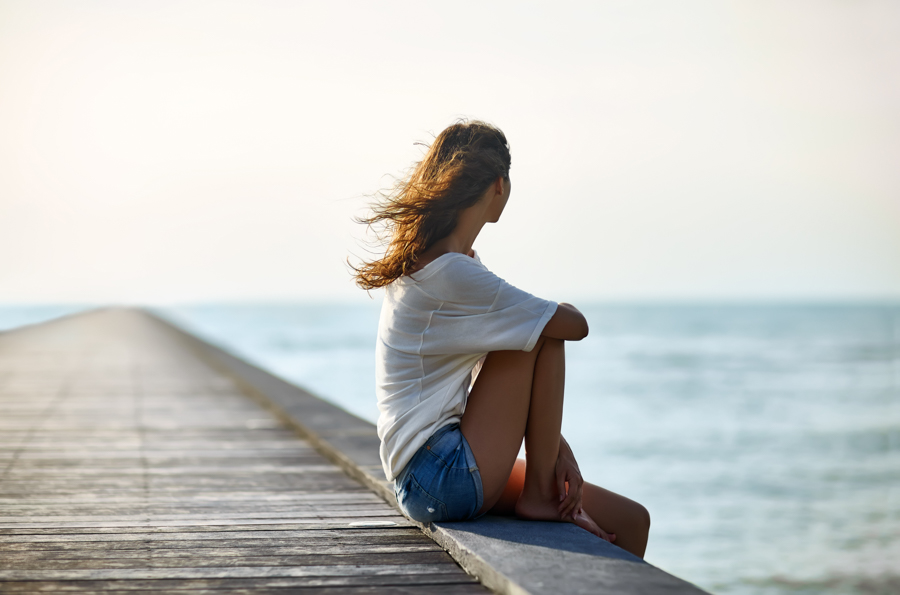 a girl relaxing by the seashore during dual diagnosis recovery in California